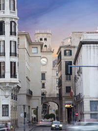 Traffic on road amidst buildings in city