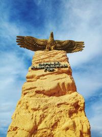 Low angle view of statue against rock formation