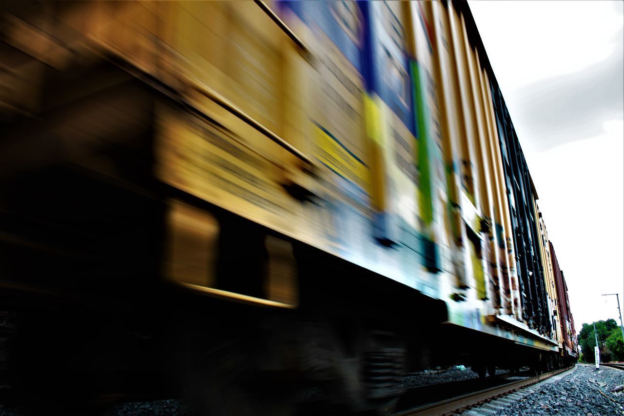 BLURRED MOTION OF TRAIN AT RAILROAD STATION PLATFORM