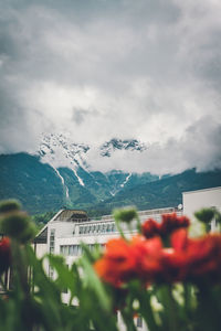 Scenic view of buildings and mountains against sky