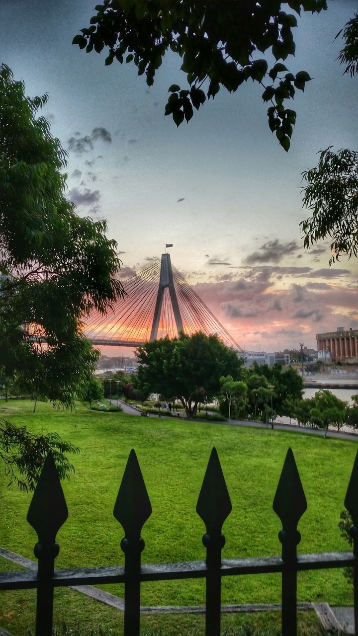 built structure, tree, architecture, grass, sky, famous place, travel destinations, park - man made space, international landmark, tourism, metal, green color, building exterior, travel, monument, lawn, cloud - sky, capital cities, history, fence