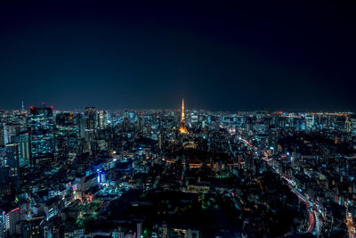 Aerial view of illuminated cityscape against clear sky