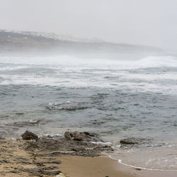 Scenic view of sea against cloudy sky