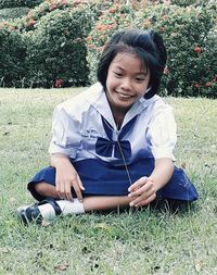Smiling girl sitting on grass