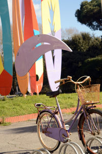 Bicycle parked amidst rack on footpath at park