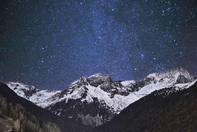 Scenic view of mountains against sky at night