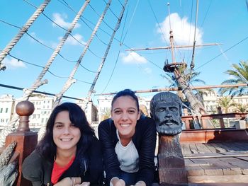 Portrait of a smiling young woman against blue sky