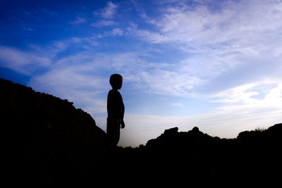 Silhouette man standing against sky during sunset