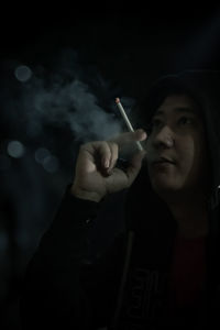 Portrait of man smoking cigarette