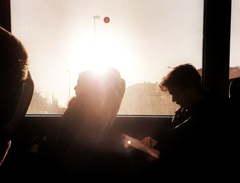 Portrait of people sitting in window