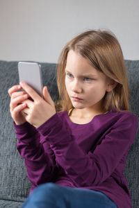 Close-up of girl using mobile phone