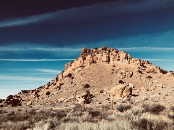 Rock formations on landscape against sky