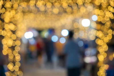 Defocused image of illuminated lights in city at night