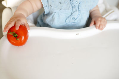 Midsection of baby girl eating food