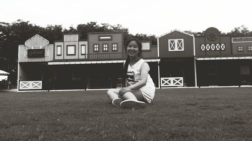 Full length of young woman on field against sky