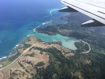 Aerial view of airplane wing over landscape