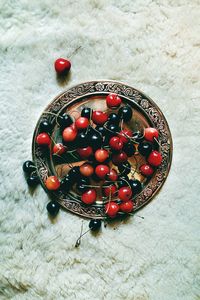 High angle view of red berries on table