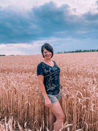 Woman standing in field against sky