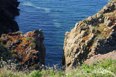 High angle view of rocks by sea