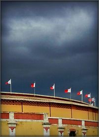 Low angle view of building against cloudy sky