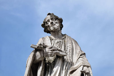 Low angle view of statue against blue sky