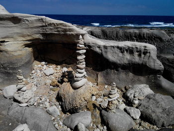 Rocks on beach against sky