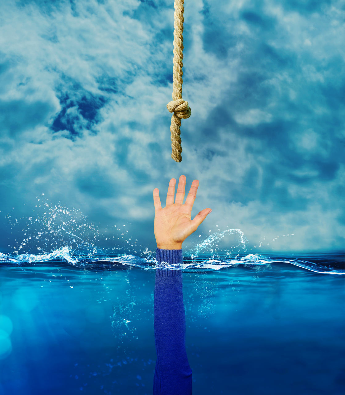 LOW ANGLE VIEW OF PERSON HAND ON SWIMMING POOL