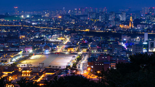 High angle view of city lit up at night