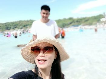 Portrait of smiling young woman in sea