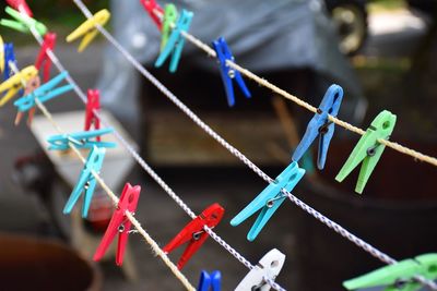 High angle view of multi colored clothespins hanging on clotheslines