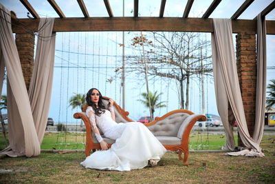 Portrait of bride sitting on sofa