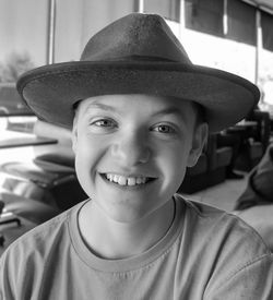 Black and white portrait of happy boy wearing hat