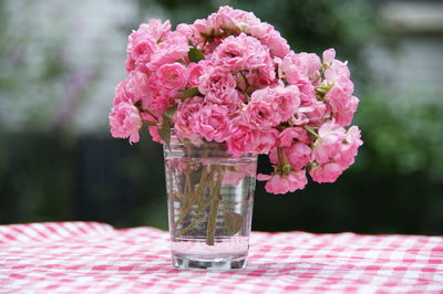 Close-up of pink rose on table