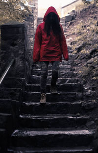 Rear view of woman walking on staircase