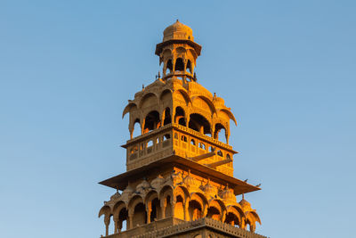 Low angle view of historical building against clear blue sky