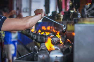 Cropped hand of man preparing food