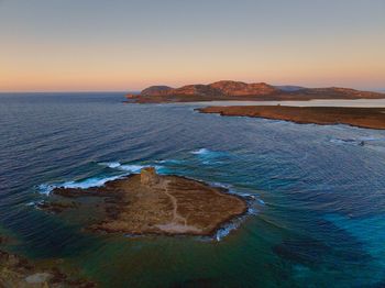 Scenic view of sea against clear sky during sunset