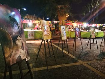 People standing on illuminated street at night