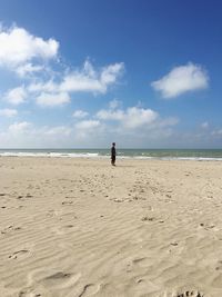 Mid distance of man standing against sea at beach