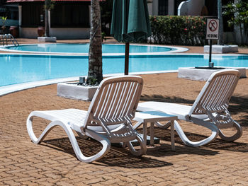 Empty chairs and tables in yard