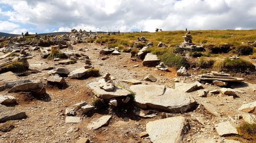 Panoramic view of rocks on field against sky