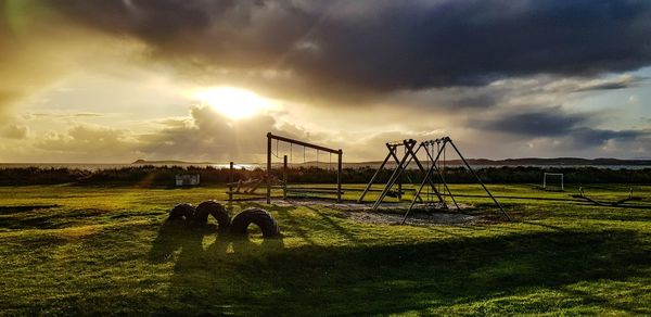 Scenic view of field against sky during sunset