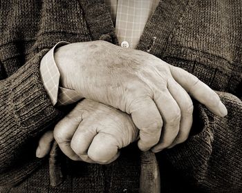 Midsection of senior man with walking cane