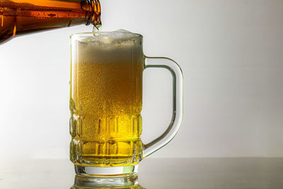 Close-up of beer glass on table