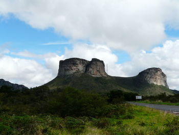 Low angle view of castle on mountain against sky