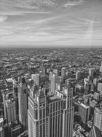 High angle view of modern buildings in city against sky