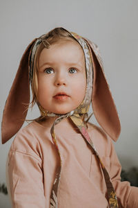 Toddler baby girl in funny hat with ears having fun