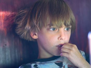 Close-up of boy with blond hair looking away