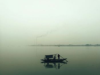 Scenic view of lake against sky during foggy weather