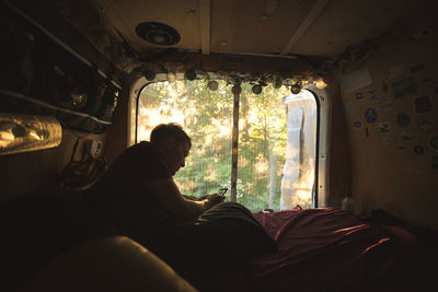 Young man resting in camper van